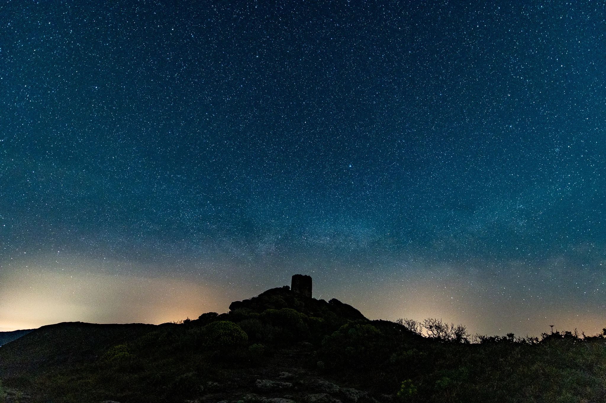 A historic Observation Tower Torre Foghe and breathtaking night sky, Sardinia.